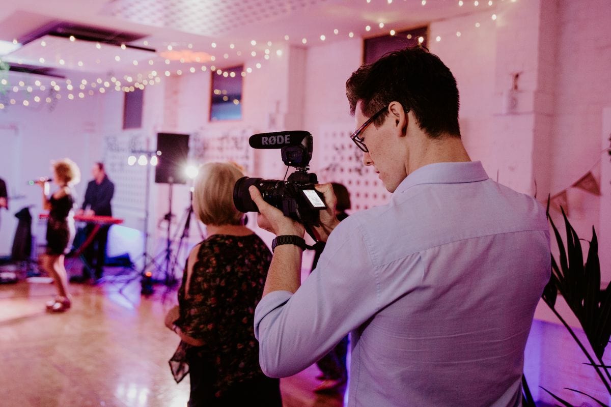 Discreet wedding videographer at work